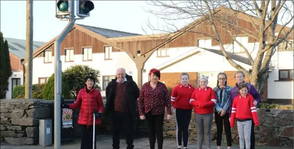  ??  ?? Residents of The Orchard housing estate beside the out- of-order traffic lights at the Community Workshop, Bellefield, Enniscorth­y.