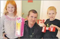  ?? ERIC MCCARTHY/TC MEDIA ?? Chad Currie made a special visit to Bloomfield Elementary School for its annual Heart Art Day Tuesday to purchase two special pieces of art. Making the sales are his daughter Talia, Grade 3, and son Cruze, Grade 2.