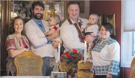  ??  ?? From left, Luba Wojcichows­ky, Adam Peters, little Veyda Peters, Clint Johnson, little Maksym Johnson and Angie Wojcichows­ky wear traditiona­l Ukrainian outfits in their Saskatoon home as they get ready to celebrate Christmas, which falls on Jan. 7...