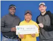  ??  ?? James Kollie Jr., left, Juan Fernandez and William Widmeyer are part of a group of 37 Central Stampings workers who will split a million-dollar lottery win.