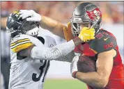  ?? MARK LOMOGLIO — THE ASSOCIATED PRESS ?? Tampa Bay tight end Cameron Brate, right, battles with Pittsburgh defensive back Nat Berhe after a reception Monday.