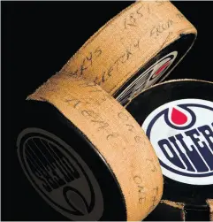  ?? POSTMEDIA NEWS ?? A puck labelled “This one is the real one” is pictured along with two other pucks from the night that Wayne Gretzky scored his record-setting 1,851st NHL point.