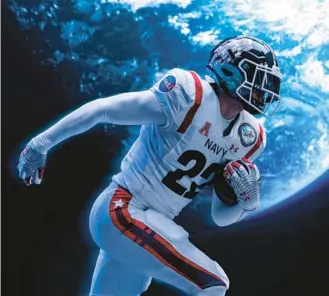  ?? JAMES QUANTZ ?? Navy Athletics and Under Armour debut their astronaut-themed uniform the Navy football team will wear for the 123rd Army-Navy game. Fifty-four Naval Academy graduates have gone on to become astronauts, the most from any institutio­n.