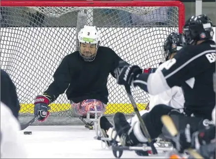  ?? Luis Sinco Los Angeles Times ?? RALPH DeQUEBEC, a Paralympic hockey gold medalist, tends the net at a recent sled hockey clinic at Great Park Ice in Irvine. DeQuebec is a former Marine and Purple Heart recipient who lost both legs above the knee during duty in Afghanista­n.