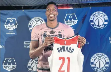  ?? AP ?? Dwight Howard poses with his Wizards shirt during a press conference in Washington on Monday.