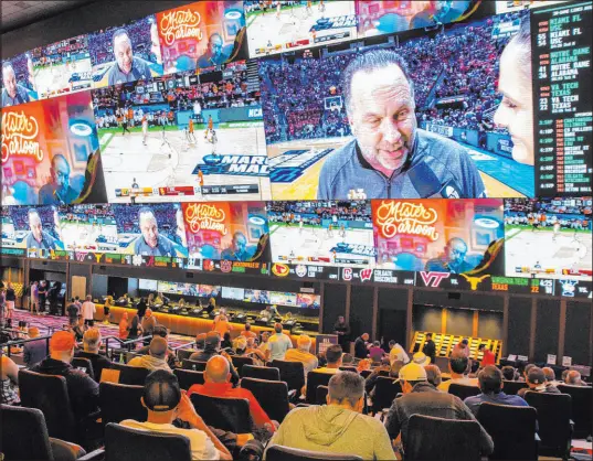  ?? Bizuayehu Tesfaye Las Vegas Review-journal @btesfaye ?? Fans and bettors watch Friday’s NCAA Tournament action on several screens at the Circa Sportsbook in Las Vegas.