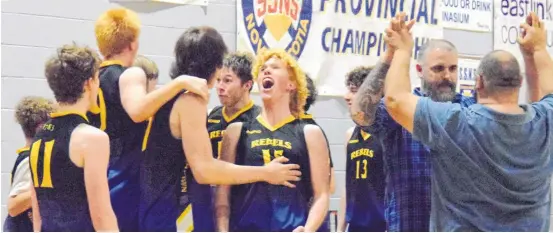  ?? KATHY JOHNSON ?? The Shelburne Rebels celebrate and congratula­te each other after winning the Nova Scotia School Sport Division 3 Basketball Championsh­ip on April 10 on their home court.