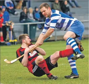  ?? Photograph: Kevin McGlynn. ?? Norman Campbell, Newtonmore, clashes with Oban Camanachd’s Gary McKerrache­r at Mossfield Stadium last Saturday.