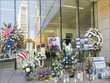  ?? Irfan Khan Los Angeles Times ?? FLOWERS AND other items are left at the LAPD headquarte­rs to pay tribute to slain Officer Juan Jose Diaz.