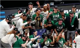  ?? Photograph: Robert Deutsch/USA Today Sports ?? The Baylor Bears celebrate with the South Region trophy after beating the Arkansas Razorbacks on Monday in the Elite Eight of the NCAA tournament at Lucas Oil Stadium.