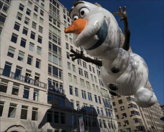  ?? CRAIG RUTTLE — THE ASSOCIATED PRESS ?? The Olaf balloon glides over Central Park West during the Macy’s Thanksgivi­ng Day Parade in New York, Thursday.