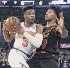  ?? Frank Franklin II / Associated Press ?? New York’s Dennis Smith Jr. tries to drive past Cleveland’s Collin Sexton on Thursday. Smith had 16 points, Sexton 22.