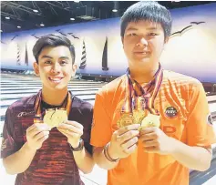  ??  ?? Christophe­r Tiong (right) and Mohd Uzair with their medals.