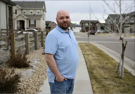  ?? ANDY CROSS — THE DENVER POST ?? Derek Rinehart stands on a sidewalk on the side of his house in Commerce City on Wednesday. Rinehart would like to xeriscape the strip of land nearest to the street and another in front of the house, but Commerce City’s landscapin­g code will not allow him to do it.