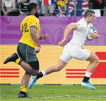  ??  ?? RIGHT
England’s Jonny May, right, runs past Australia’s Samu Kerevi to score a try during their quarter-final match.