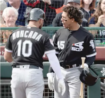  ?? JENNIFER STEWART/GETTY IMAGES ?? Jon Jay (right) will get extra at-bats by leading off every inning during a minor-league game Monday.