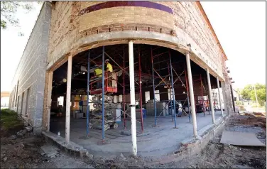  ?? NWA Democrat-Gazette/FLIP PUTTHOFF ?? Work progresses Thursday on remodeling the Hailey Ford building in downtown Rogers for an expansion of the Rogers Historical Museum. For years, the building housed the