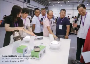  ??  ?? Local residents see a demonstrat­ion of smart speakers and lamps at an expo in Qingdao in 2019