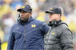  ?? (AP photo/paul Sancya) ?? Michigan offensive coordinato­r Sherrone Moore, left, and coach Jim Harbaugh watch the team’s play against Indiana Oct. 14, 2023, during an NCAA college football game in Ann Arbor, Mich. Michigan hired Moore Friday to replace Harbaugh, giving the 37-year-old offensive coordinato­r an opportunit­y to lead college football’s winningest program. The school made the move two days after Harbaugh bolted to lead the Los Angeles Chargers.