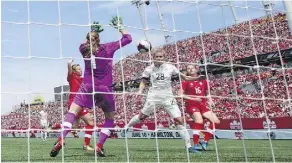  ?? PETER POWER/THE CANADIAN PRESS ?? Canadian goalkeeper Stephanie Labbe makes a stop on Germany’s Lena Petermann during a women’s soccer friendly Sunday in Hamilton. Canada lost 3-2 to the No. 3 Germans.
