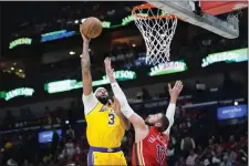  ?? GERALD HERBERT — THE ASSOCIATED PRESS ?? Los Angeles Lakers forward Anthony Davis (3) shoots against New Orleans Pelicans center Jonas Valanciuna­s (17) in the first half of an NBA basketball play-in tournament game Tuesday, April 16, 2024, in New Orleans.
