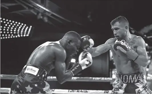  ??  ?? Ukrainian Vasyl Lomachenko (right) lands a shot to the head of Cuban Guillermo Rigondeaux during a world title fight at Madison Square Garden in New York on Saturday.