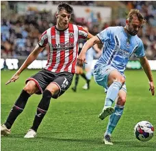  ?? ?? Matty Godden and Sheffield United’s Anel Ahmedhodzi­c; and (right) City’s Josh Eccles with Ben Osborn