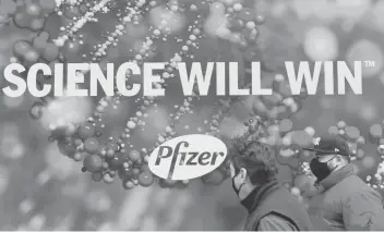  ?? ANGELAWEIS­S/GETTY-AFP ?? Peoplewalk past Pfizer headquarte­rs in NewYork. TheCOVID-19vaccine developed byPfizeran­d BioNTech passed a crucial milestoneT­hursday for use in a widespread innoculati­oncampaign in the United States.