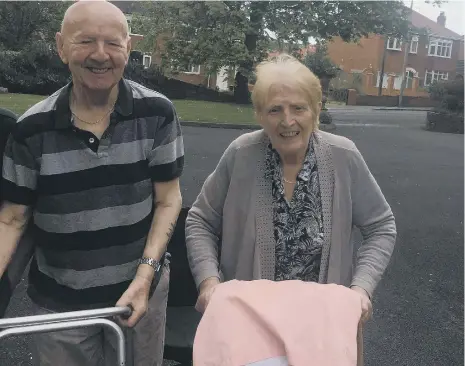  ??  ?? Residents Jimmy and Mary taking part in the walk which has so far raised £785.