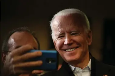  ?? NANCY LANE / HERALD STAFF ?? ‘HILLARY WITHOUT HAIR’: Ex-Vice President Joe Biden poses for a selfie with a supporter Wednesday in Somerswort­h, N.H.