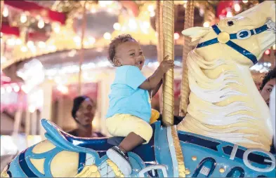  ?? KASSI JACKSON/HARTFORD COURANT PHOTOS ?? Dylon Mundle, 10 months, enjoys a ride Saturday during the Bushnell Park Carousel 105th birthday party.
