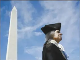  ?? AP file photo ?? John Lopes, playing the part of President George Washington, stands near the Washington Monument following a ribbon-cutting ceremony with first lady Melania Trump to re-open the monument, on Sept. 19, 2019, in Washington. Like the other Founding Fathers, George Washington was uneasy about the idea of publicly celebratin­g his life. He was the first leader of a new republic — not a tyrant.