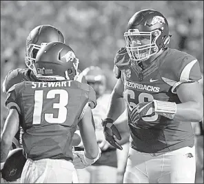  ?? NWA Democrat-Gazette/BEN GOFF ?? Arkansas freshman offensive lineman Ty Clary (right) has two things going for him in today’s game against TCU, said Coach Bret Bielema. “He already has one start under his belt and he’s playing next to Frank Ragnow, who I think is one of the most...