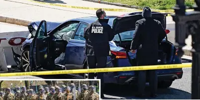  ??  ?? Horror: Car that crashed into barrier. Left: National Guard troops are mobilised