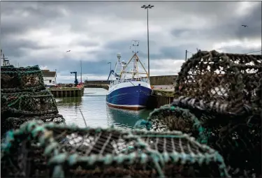  ?? AP PHOTO/DAVID KEYTON, FILE ?? In this Jan. 28 file photo, a fishing vessel is docked at Kilkeel harbor in Northern Ireland. Fishing has become one of the main stumbling blocs in the Brexit negotiatio­ns for a new trade deal between the European Union and the United Kingdom.