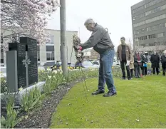  ?? JULIE JOCSAK/STANDARD FILE PHOTO ?? Peter Barber lays a wreath during the National Day of Mourning ceremony in St. Catharines last year.