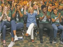  ?? JERRY LARSON/WACO TRIBUNE-HERALD VIA AP ?? Baylor head coach Kim Mulkey, center, and players react Monday in Waco, Texas, after they hear they are seeded No. 2 during the NCAA selection show.