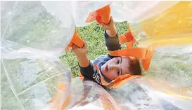  ??  ?? Five-year-old Hunter Gibson of Warragul holds on tight as he is bounced around in the bubble ball battles at Burke Street park as part of Victorian youth week celebratio­ns.