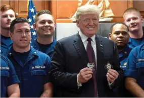  ??  ?? Thanksgivi­ng holiday: President Trump with coast guard members