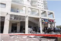  ?? (Marc Israel Sellem/The Jerusalem Post) ?? THE SCENE of a high-rise building in Ashkelon that was damaged by a rocket earlier this week.