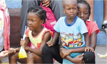  ?? (Jose Torres/Reuters) ?? HAITIAN CHILD migrants wait with their families to hand in refugee applicatio­ns for Mexico, outside the Mexican Commission for Refugee Assistance in Tapachula, Mexico, in July.