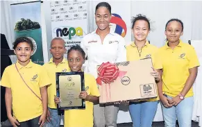  ??  ?? Toni-Ann Reid, marketing officer with Total Jamaica, presents the winning award for first place Best Display at the SEP Research Day and Awards Ceremony last month.