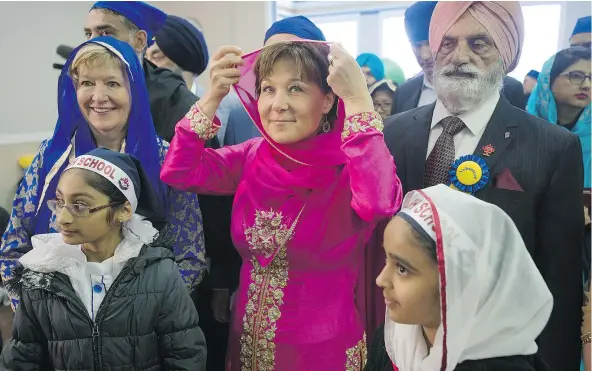  ?? PHOTOS: JASON PAYNE/PNG ?? B.C. Liberal Leader Christy Clark joins in the Vaisakhi celebratio­ns in Vancouver with Suzanne Anton, left, the Liberals’ incumbent in Vancouver-Fraserview. Vaisakhi celebratio­ns will continue next Saturday in Surrey.