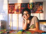  ?? JANE TYSKA/STAFF ?? Favianna Rodriguez is surrounded by artwork in her studio in Oakland. Rodriguez creates art about racism, immigratio­n, globalizat­ion and other social issues.