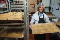  ?? TNS ?? Rachel Bernier-Green, owner of Laine’s Bake Shop, holds a tray of cookies Dec. 8 in Chicago’s Morgan Park neighborho­od. The shop sells cookies in more than 50 Whole Foods stores and 10 Starbucks locations.