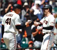  ?? JANE TYSKA/BAY AREA NEWS GROUP ?? The Giants' Mike Yastrzemsk­i is congratula­ted by Wilmer Flores (41) after hitting a two-run home run in San Francisco on Wednesday.