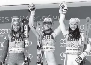  ??  ?? Winner Ilka Stuhec, center, and runner-up Elena Curtoni, left, and third-place finisher Stephanie Venier celebrate on the podium after Saturday’s super-G.