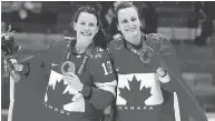  ?? AL CHAREST / POSTMEDIA NEWS ?? Team Canada’s Marie-Philip Poulin, right, and Catherine Ward shared a golden Olympic moment in Sochi in 2014.