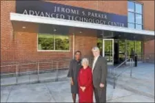  ??  ?? Delaware County Community College President L. Joy Gates Black joins former president Jerome S. Parker and his wife Sue Parker in front of the campus Advanced Technology Center that now bears Parker’s name.