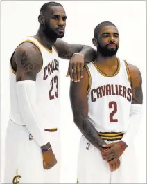  ?? RON SCHWANE/ THE ASSOCIATED PRESS ?? Cleveland Cavaliers forward LeBron James (23) and guard Kyrie Irving pose for photos during the NBA champions’ media day in Independen­ce, Ohio, on Monday. James said of the nation’s need for social change: “I’m not here to ramp on America, that’s not...